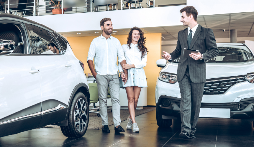 A Salesman showing customers a car in a showroom