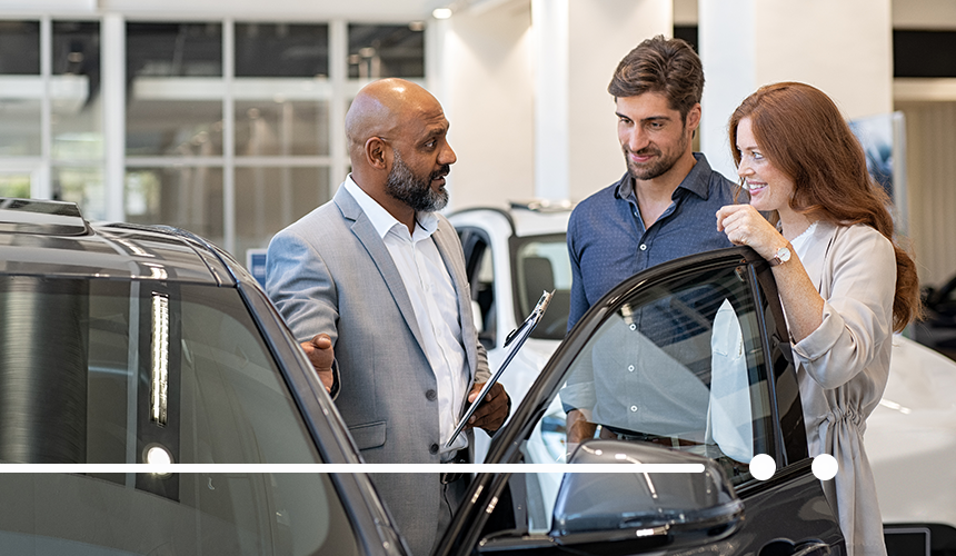 Salesperson in Car Dealership with customers