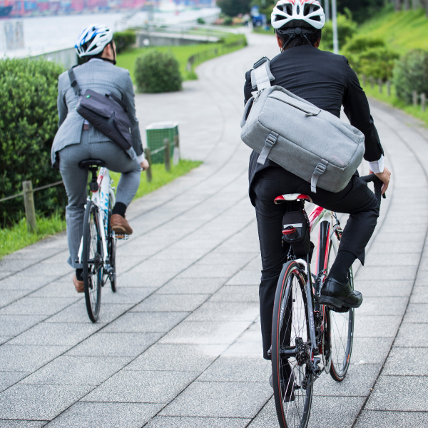 Two men in suits cycling to work